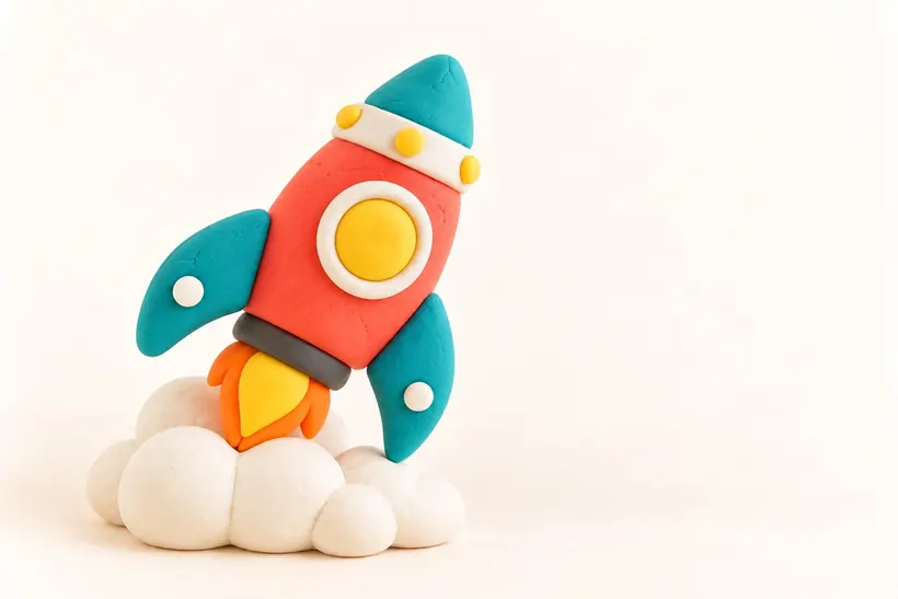 A clay rocket resting on a white cloud, made by a child
